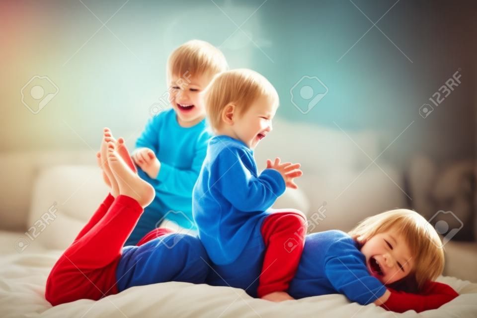 Children, brothers, playing at home, tickling feet laughing and smiling
