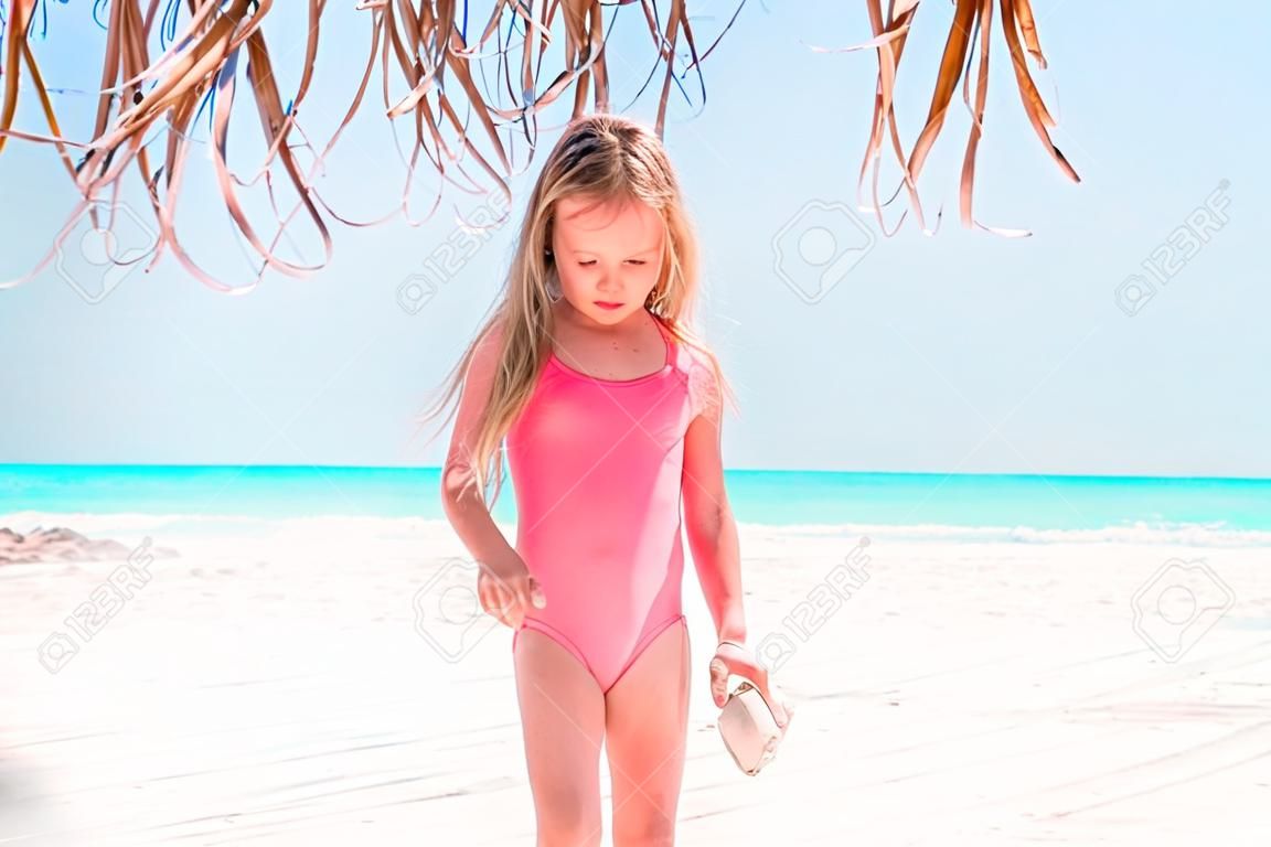 Portrait of adorable little girl at beach on her summer vacation