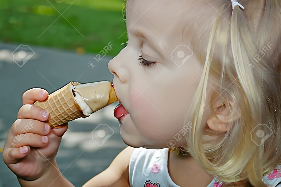Little girl is eating ice cream