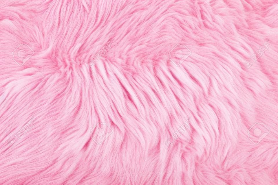 Közelkép egy rózsaszín festett báránybőr szőnyeg, mint a háttér