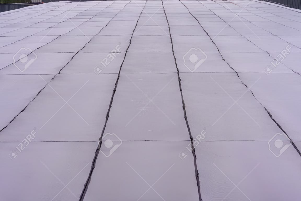 Vlakke dakcoating. Verwarming en smelten bitumen dakbedekking vilt achtergrond patroon.