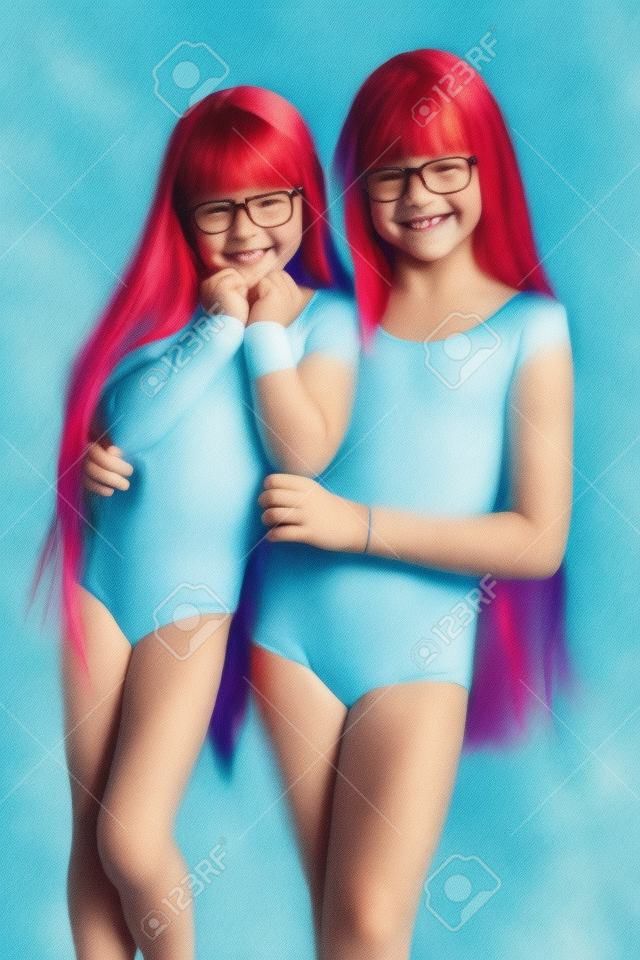 portrait of happy girls in a sports gymnastic swimsuit