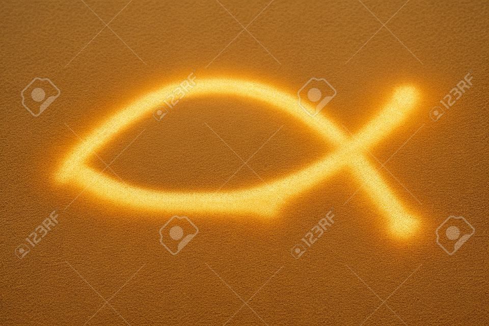 Christianity symbol - religious shape drawn in sand. Catholicism fish - ichthus.