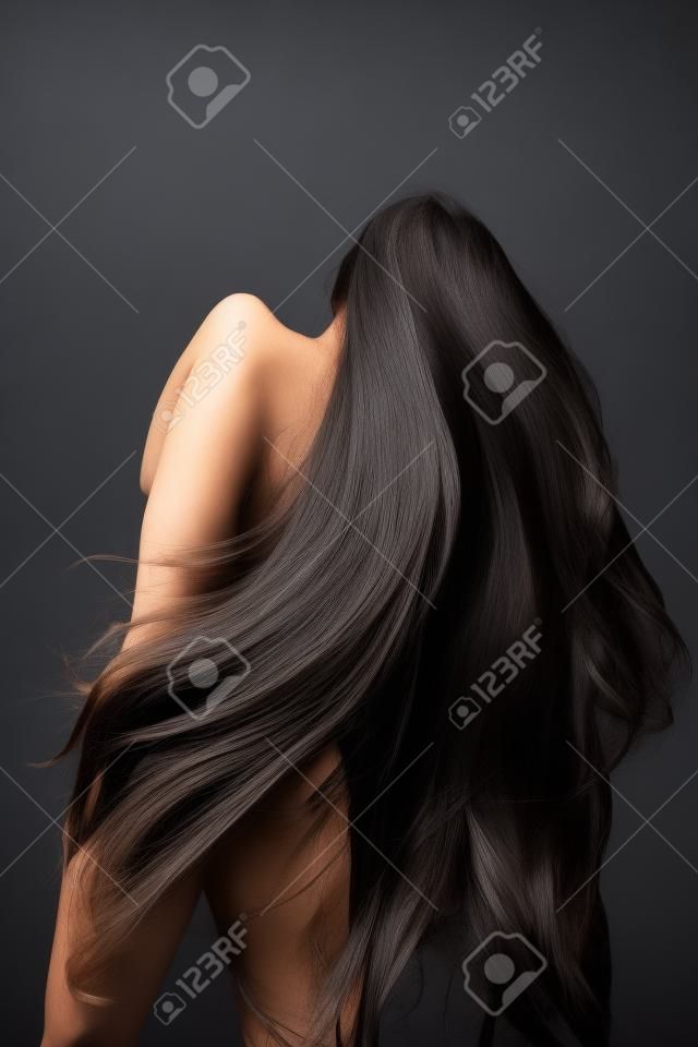 Girl has no makeup and healthy hair on black background. Woman with stylish long hair in underwear. Hairdresser and barber. Haircare and shampoo. Beauty salon and fashion.