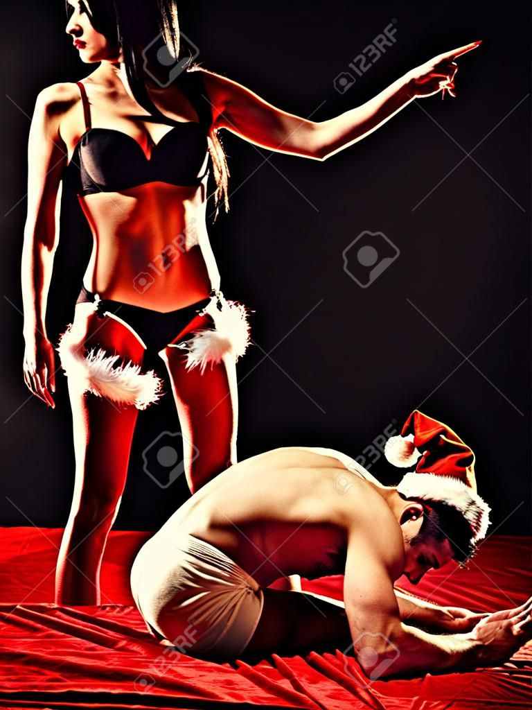 Christmas party. Domination and Submission. Woman and man playing domination games. Dominate obey undress seduce a partner.