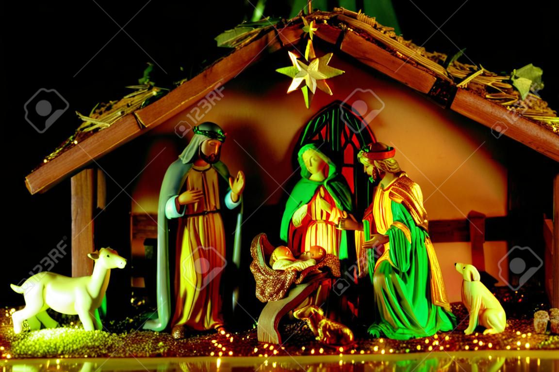 Christmas nativity scene. Christmas Jesus in crib. Christmas nativity scene of born Jesus Christ in the manger with Joseph and Mary. Traditional Christmas nativity scene of baby Jesus in the manger.