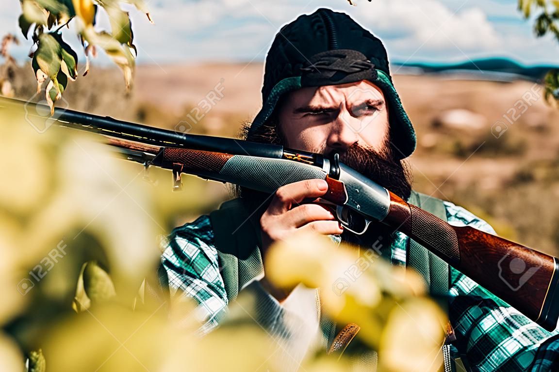 Hunter with shotgun gun on hunt. Man holding shotgun.
