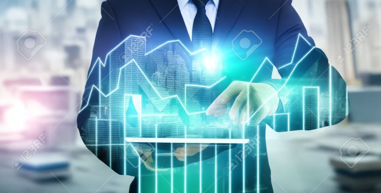 Double exposure of businessman using the tablet with cityscape and financial graph which have earth and world map on computer blurred background