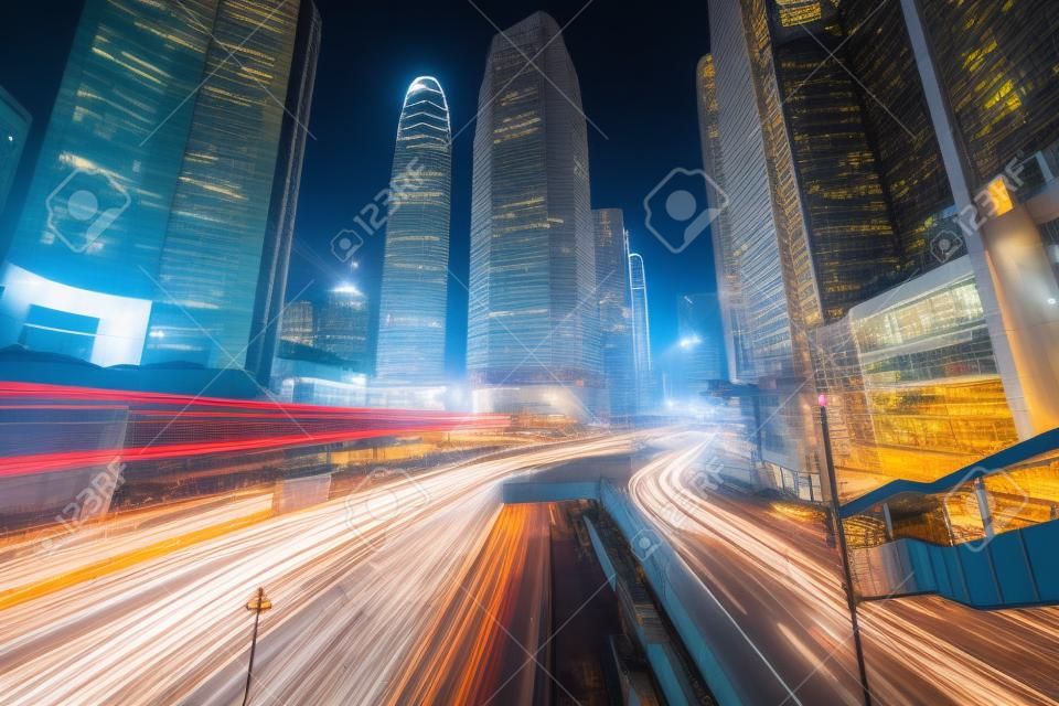 Long exposure of Hong Kong Cityscape skyscaper which have light traffic transportation from car or bus on Central Business District around IFC building, transport and energy industrial concept
