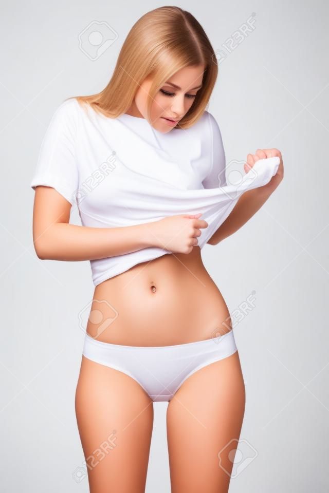 Fotografia do Stock: Attractive young woman in white underwear isolated on  white background.