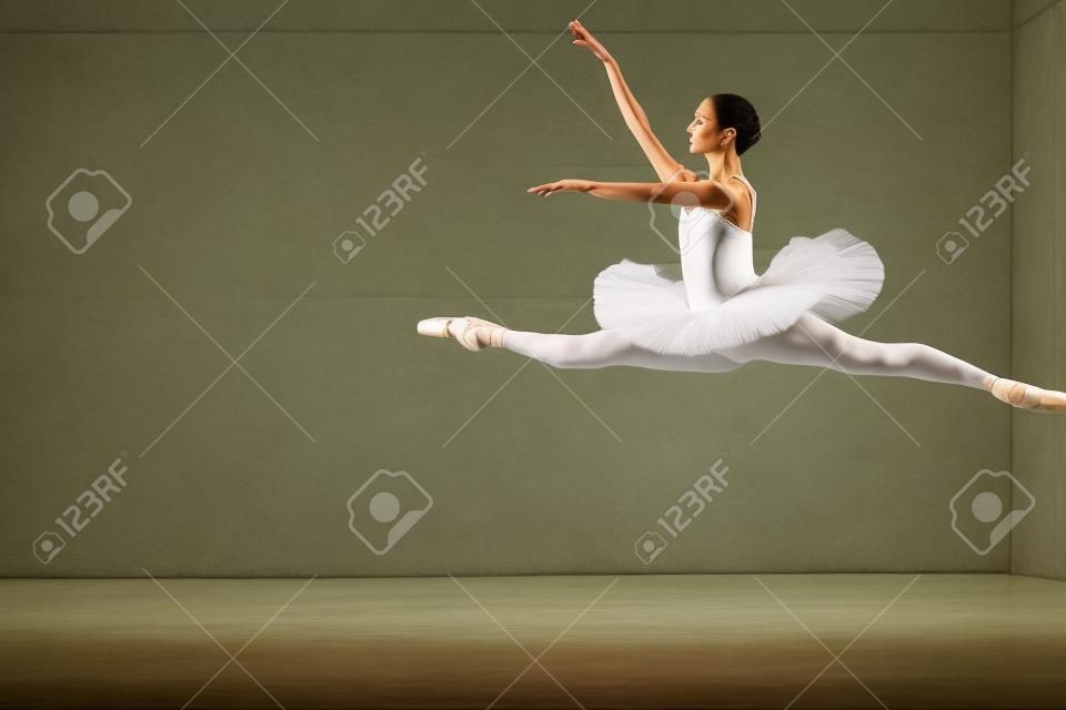 powerful jump in the ballet. full length side view photo. amazing art. classsical ballet, elegant jump