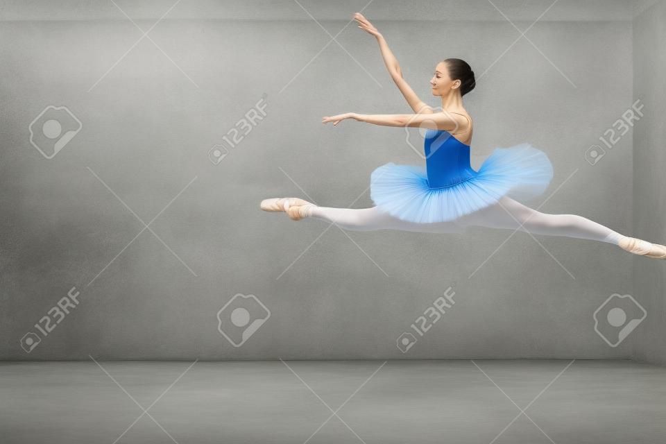 powerful jump in the ballet. full length side view photo. amazing art. classsical ballet, elegant jump