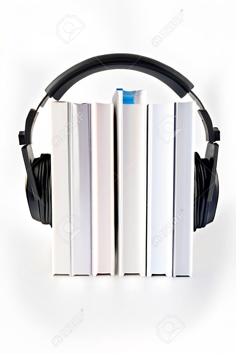 five books on a white background vertically on top of them surround headphones