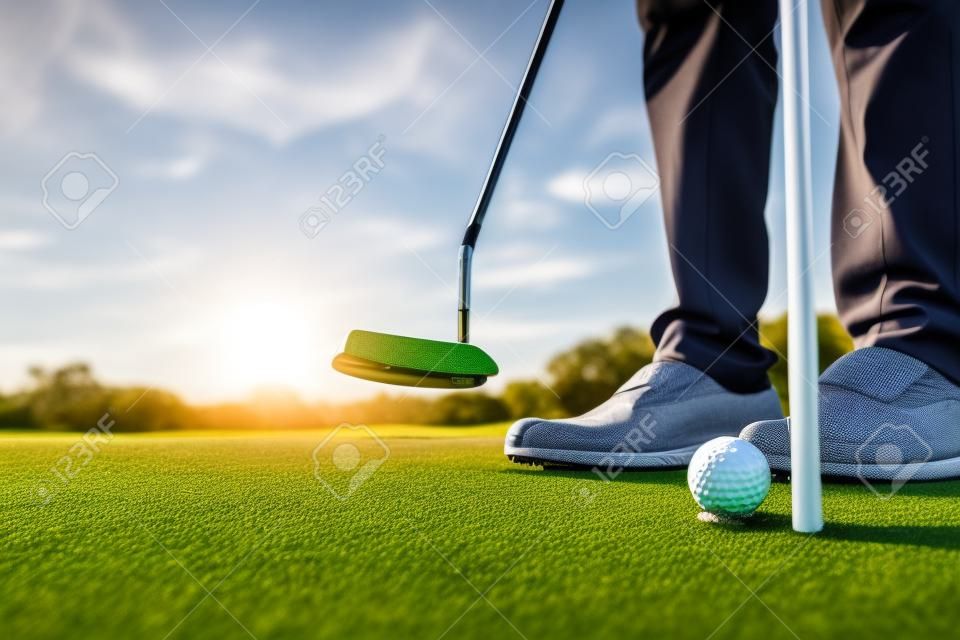 Hitting the green with the putter Putting the ball in the hole. man playing golf