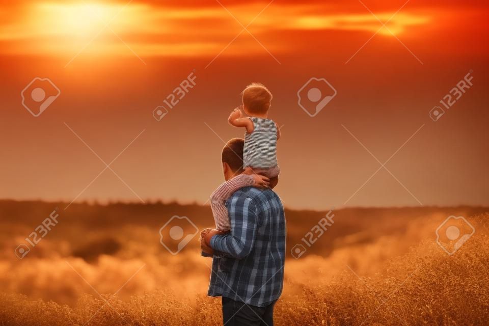 dad and daughter walking in nature at sunset concept family values, family relationships