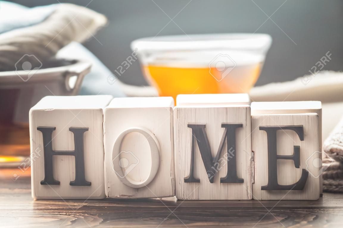 Still life home comfort with a Cup of tea and wooden letters home, the concept of comfort and home atmosphere