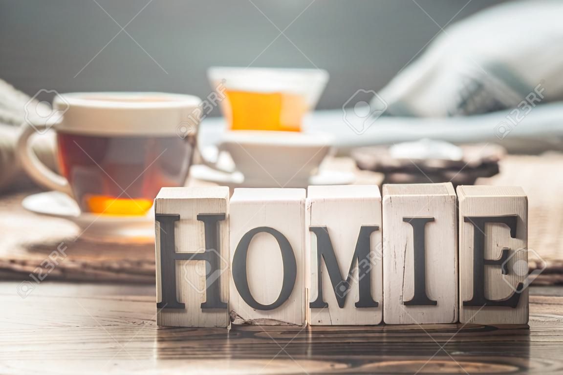 Still life home comfort with a Cup of tea and wooden letters home, the concept of comfort and home atmosphere