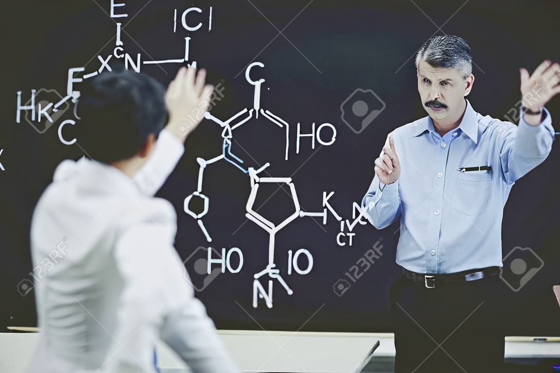 Professor Ask Student About Chemistry Formula. Teacher Leading Lecture. University Classroom. Educational Concept. Explanation for students. Educarion Process. Working Process. Male Sientist.