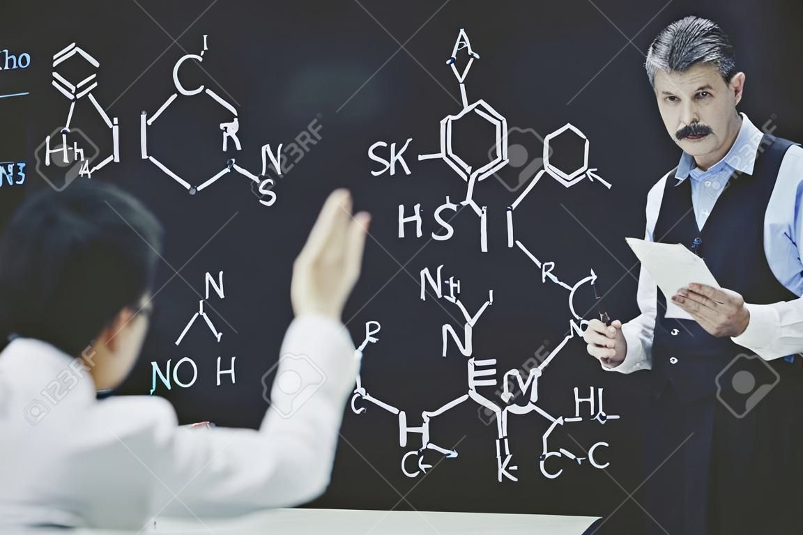 Professor Ask Student About Chemistry Formula. Teacher Leading Lecture. University Classroom. Educational Concept. Explanation for students. Educarion Process. Working Process. Male Sientist.