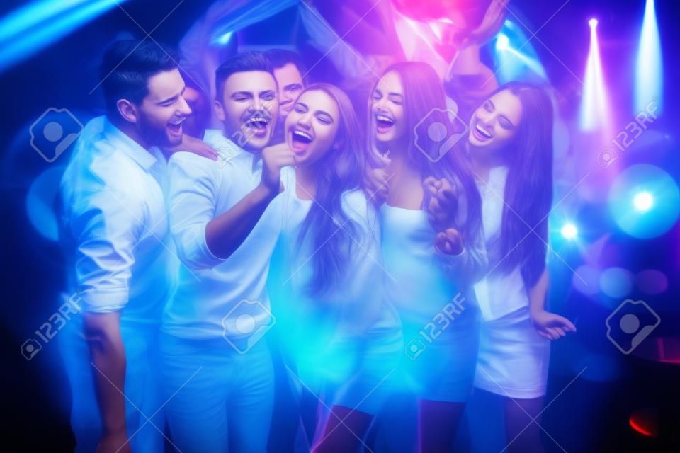 Young People. Dance Club. Sing. Men. White Shirt. Microphone. Trendy Modern Nightclub. Party Maker. Birthday. Karaoke Club. Celebration. Holidays Concept. Dancing People. Great Mood.