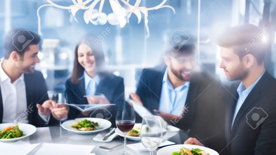 Business People Dinner Meeting Restaurant Concept. Businessmans Having Meeting In Indoor Restaurant. Group Business People Geting Order in Restaurant. Corporate, Collaboration Concept. Teamwork.