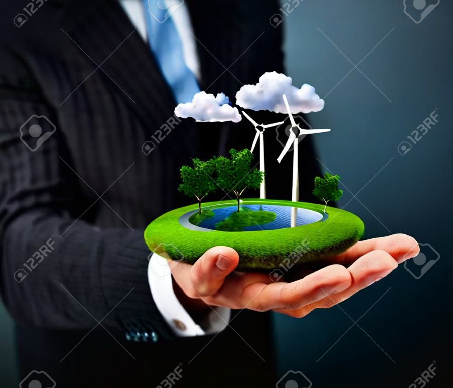 L'uomo in possesso di un prato verde con mulini a vento
