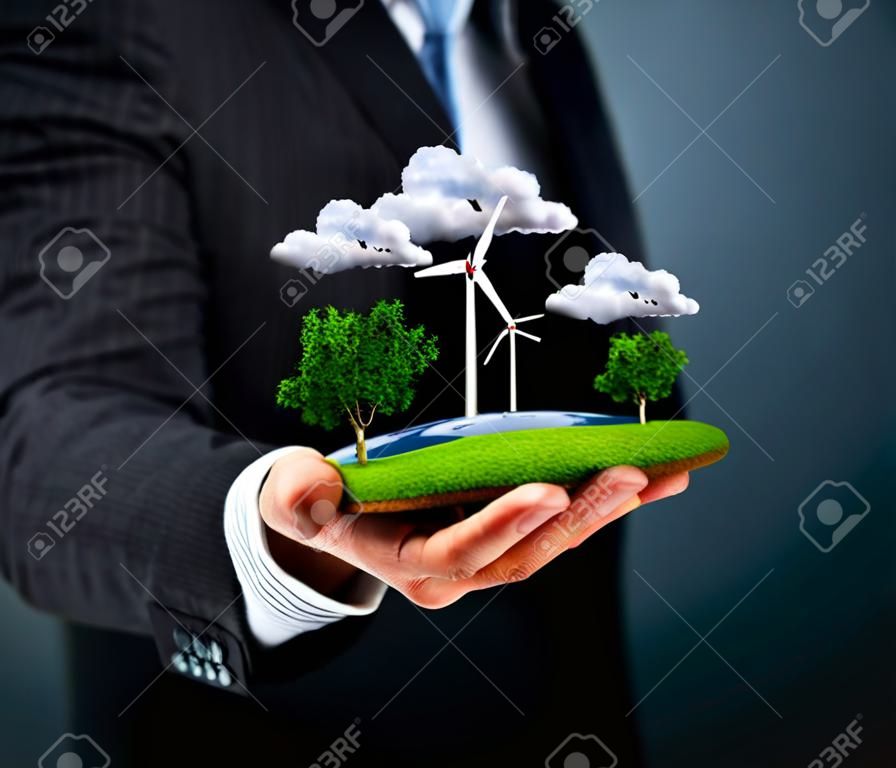 L'uomo in possesso di un prato verde con mulini a vento
