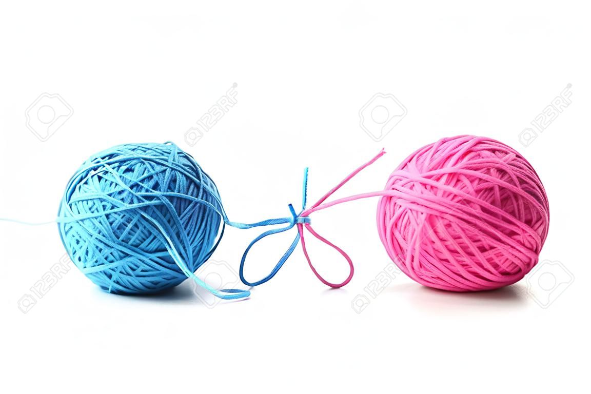 Two pink and blue cotton balls isolated on white background. Different color pink and blue thread balls.