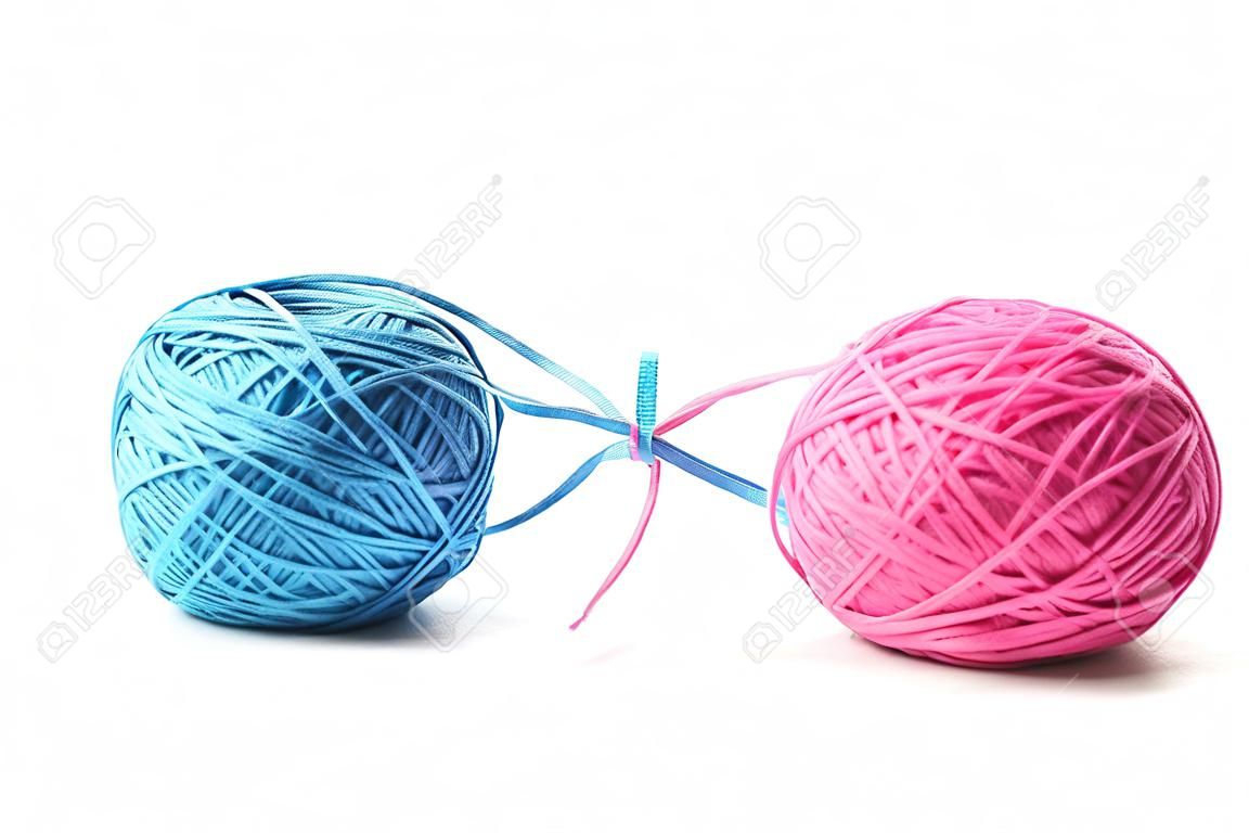 Two pink and blue cotton balls isolated on white background. Different color pink and blue thread balls.