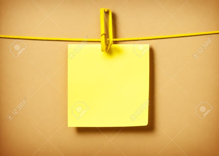 Yellow paper sticky note hanging on a rope with a clothespin. Template isolated on a transparent background. Vector background with copy space
