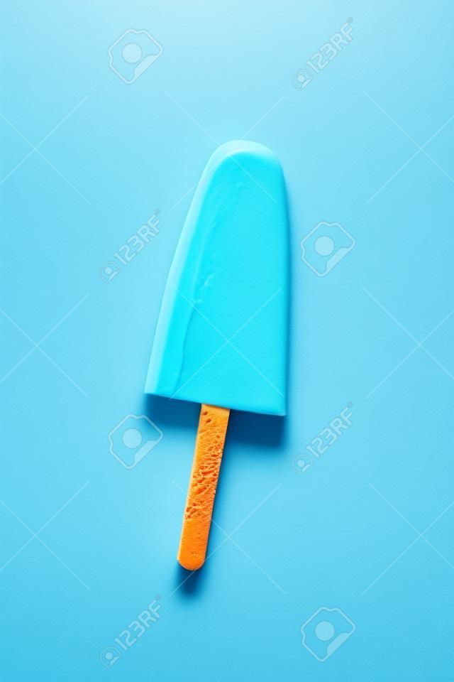 Single homemade orange ice cream on a blue background. Top view.