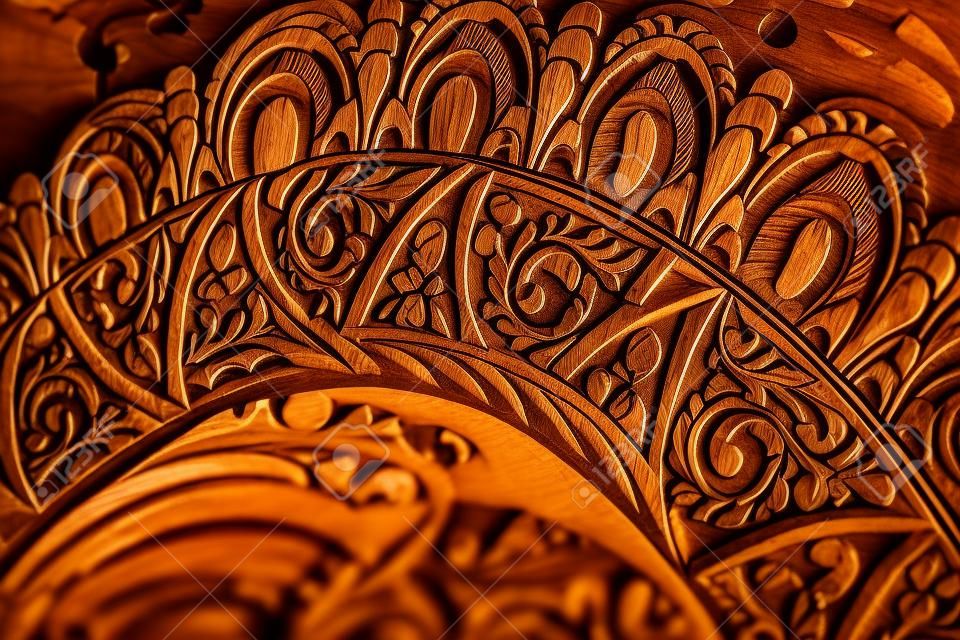 background: woodcarving fragment of a wooden homemade casket closeup