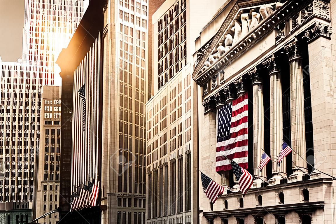 Famous Wall street and the building in New York, New York Stock Exchange with patriot flag