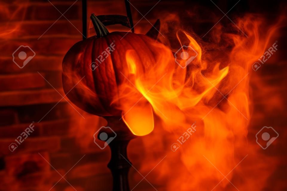 Hookah with smoke on the background of a brick wall with a pumpkin. Abstract Halloween background with pumpkin. Flashes of light, glare of light, an old empty room