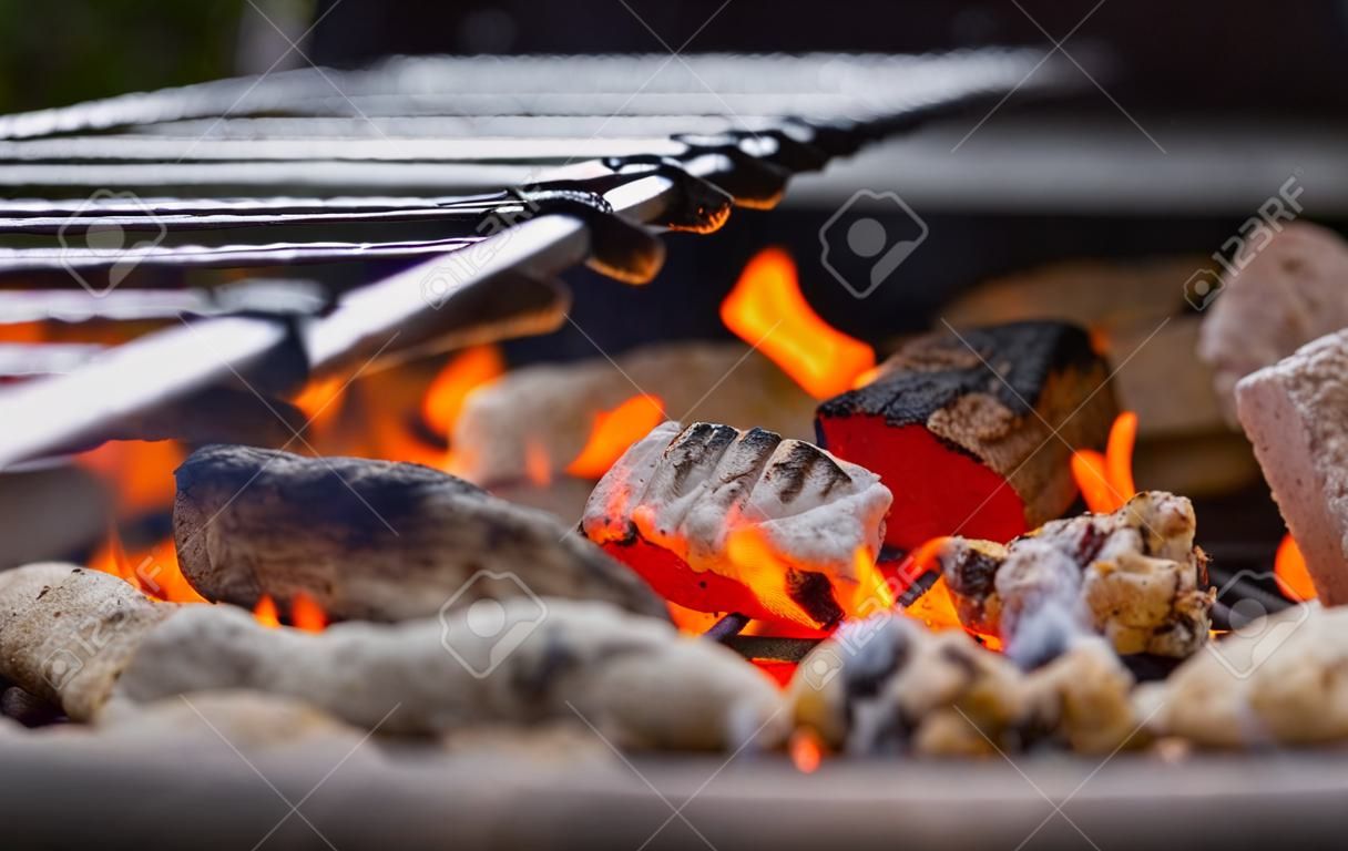 Stock image of charcoal fire grill, close up with live flames.