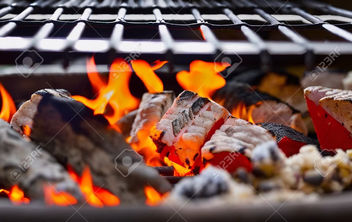 Stock image of charcoal fire grill, close up with live flames.
