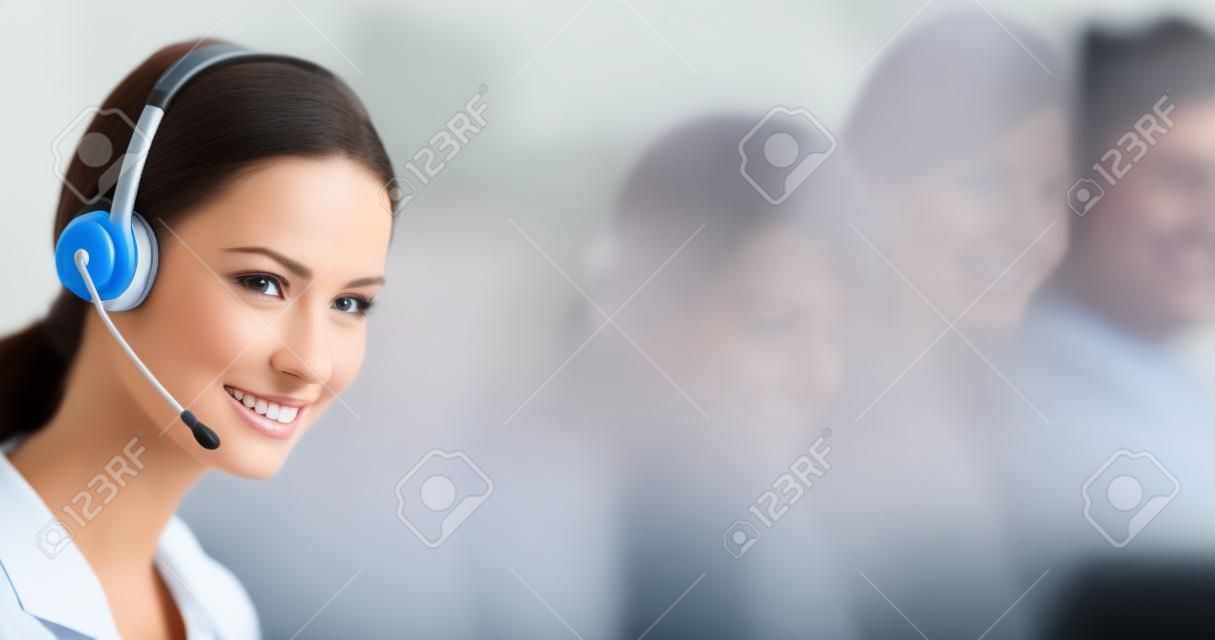 Call center help line service. Studio portrait of customer support phone sales operator in headset, blurred modern office background. Happy smiling business woman. Caller worker.