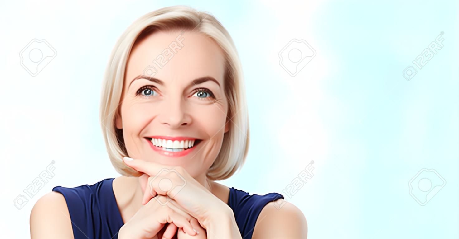 Atrakcyjna kobieta w średnim wieku z pięknym uśmiechem na białym tle