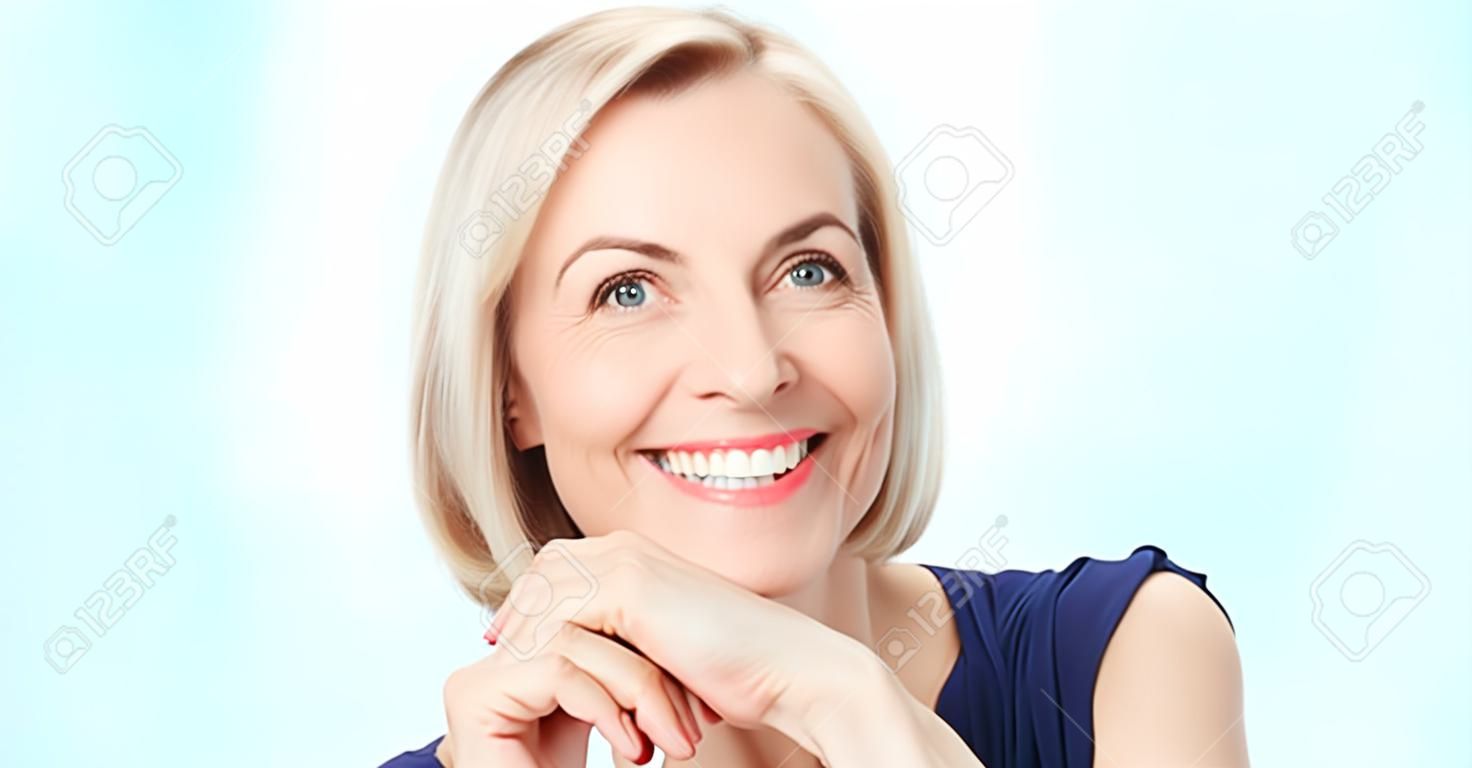 Attractive middle aged woman with beautiful smile on white background