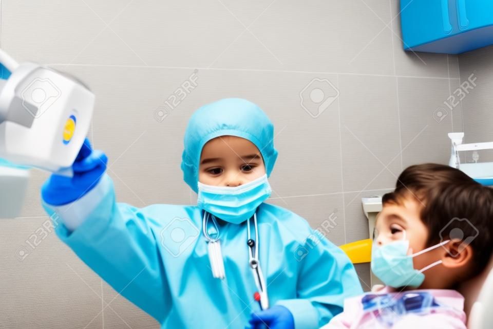 A couple of kids playing doctor at the dentist
