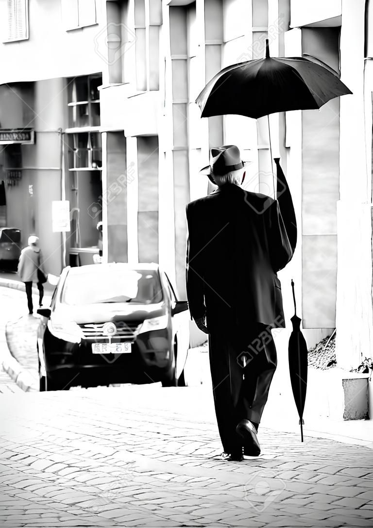 비를 위해 우산을 들고 길을 걷고 노인 노인