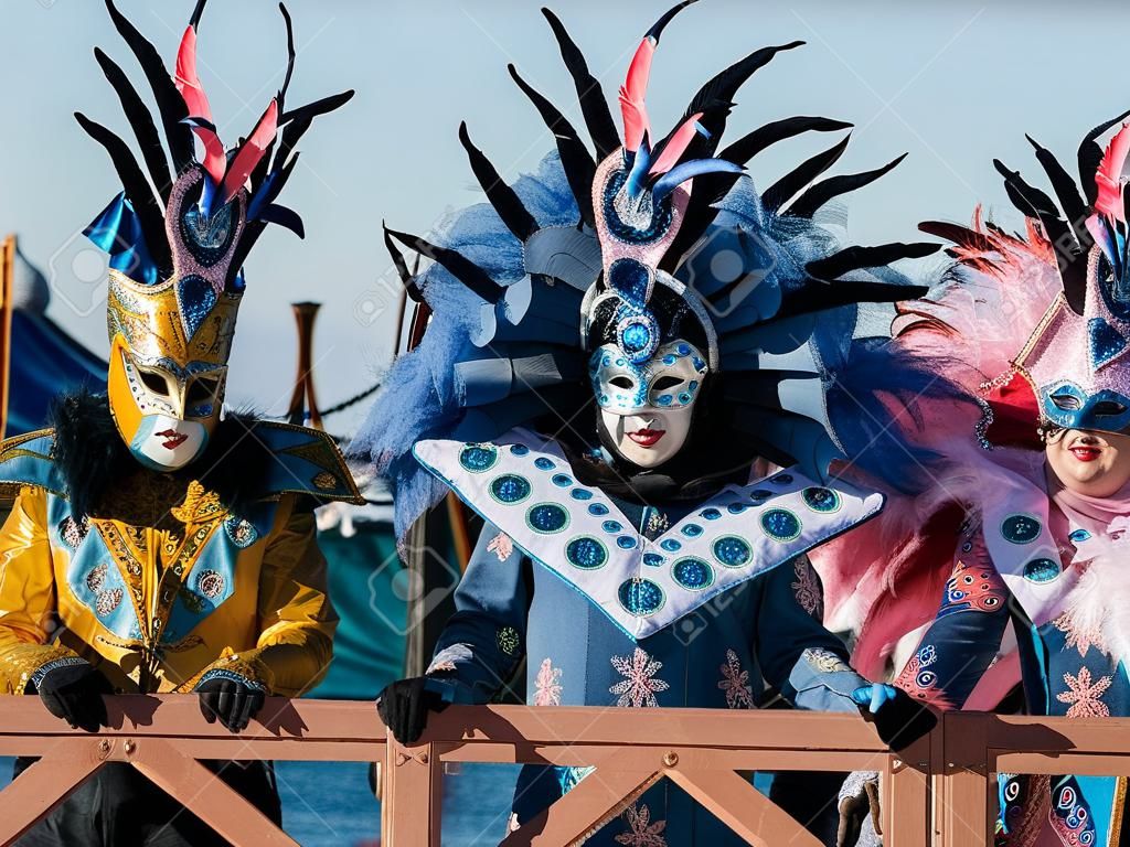 people in masks and costumes during carnival