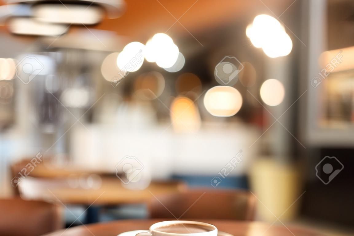Blurred image of coffee shop or cafe with bokeh lights for using as background