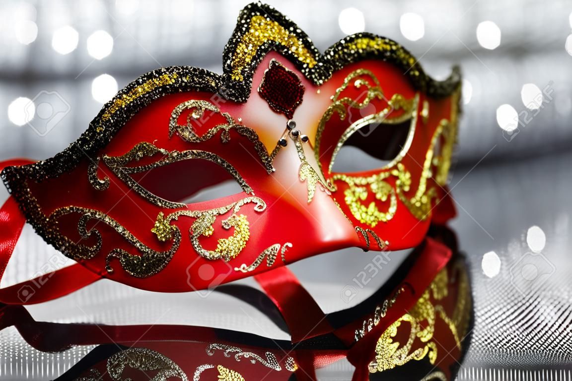 Vintage carnival mask in front of glittering background