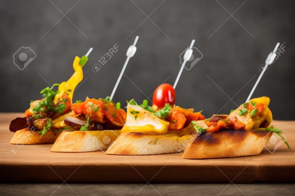 Tapas on Crusty Bread - Selection of Spanish tapas served on a sliced baguette.