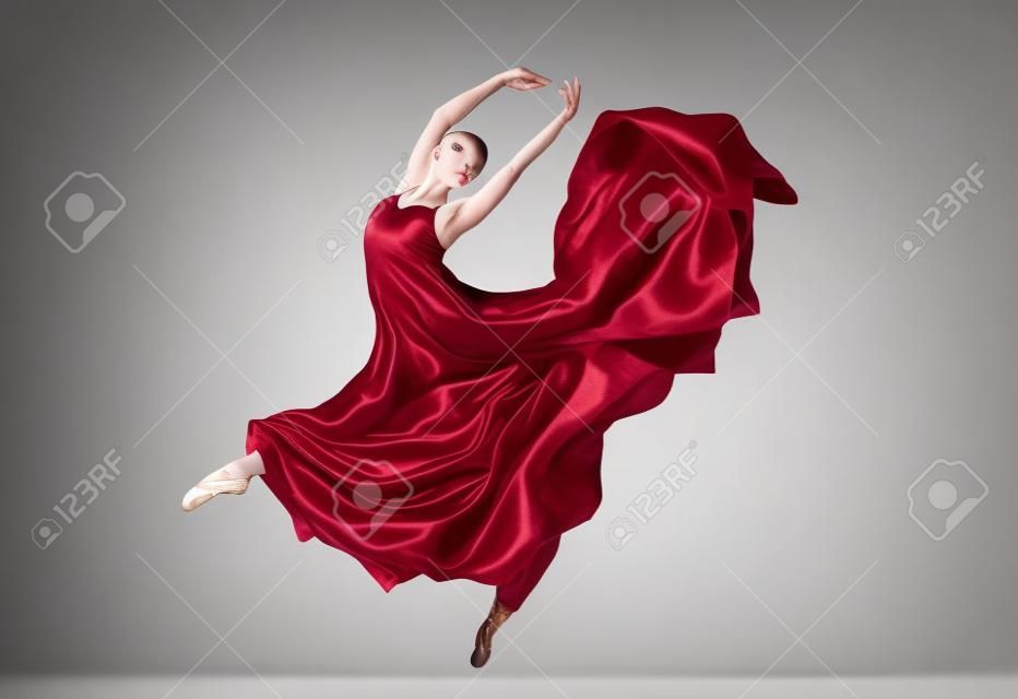 ballet dancer in flying satin dress isolated on white background
