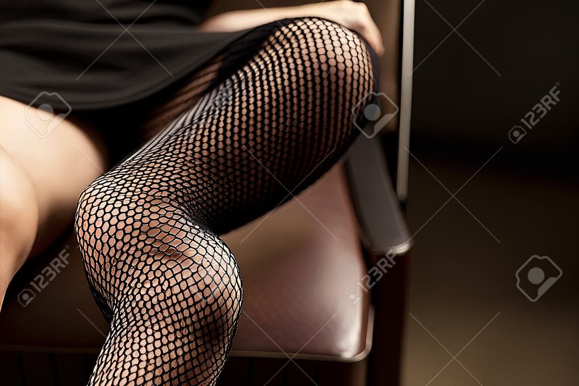 feminine crossed legs in fishnet stockings