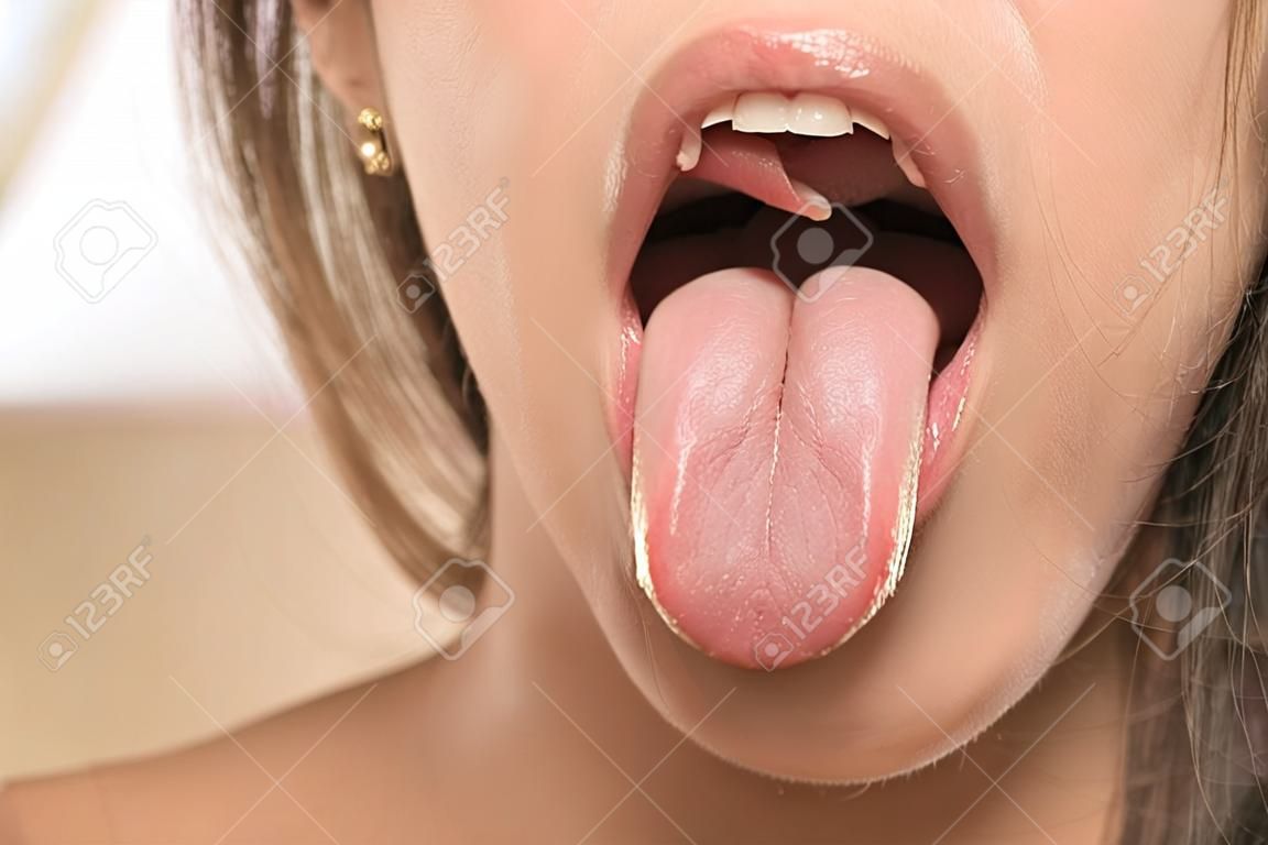 Front view of a woman tongue. Close up.