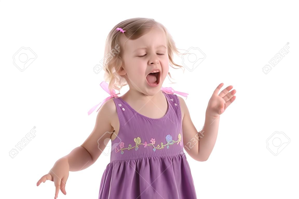 fretful little girl wearing a purple dress screaming with one's tongue hanging out and standing on white background