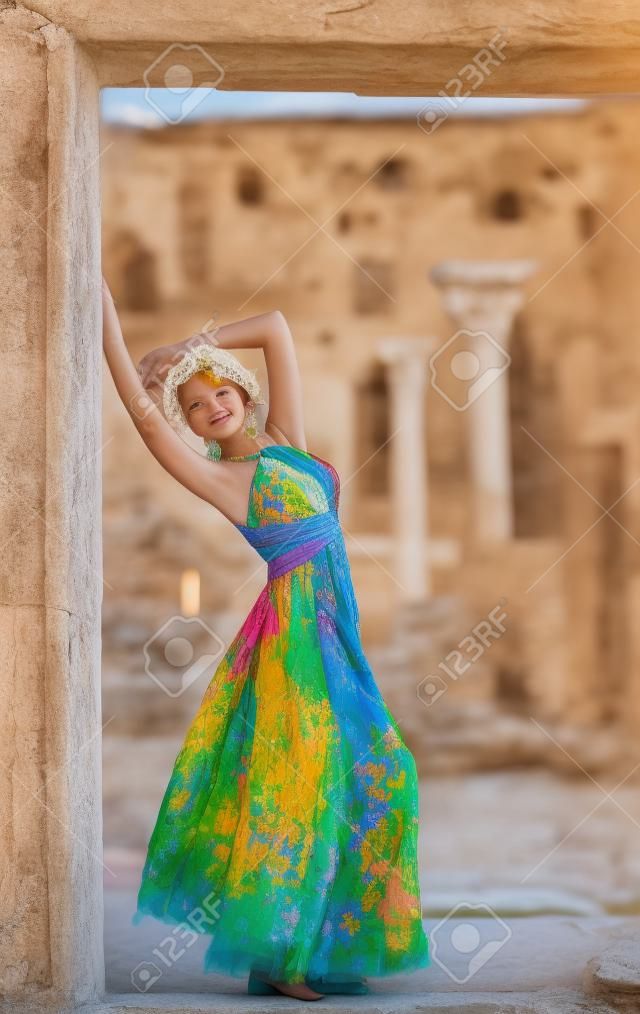 A girl in a colorful dress and the ruins of ancient Chersonese